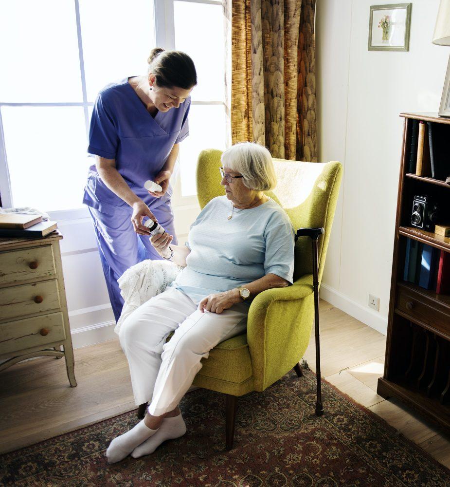 Nurse is taking care of a senior woman