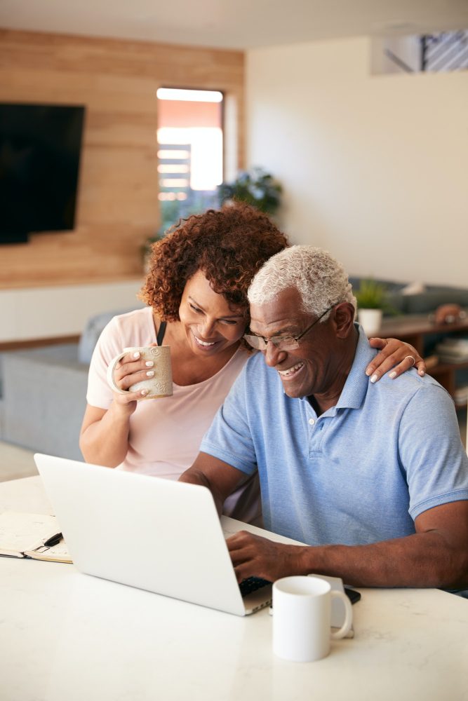 Senior African American Couple Using Laptop To Check Finances At Home